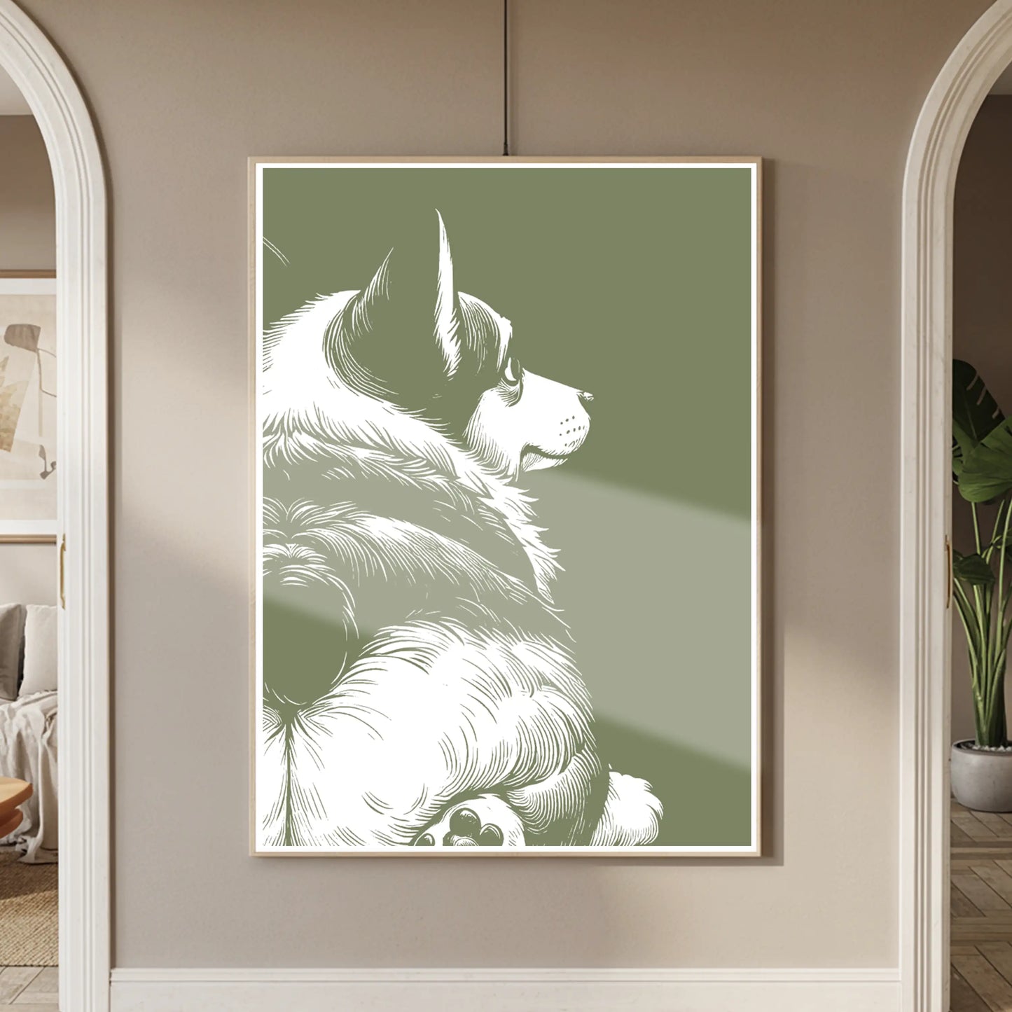 Framed artwork of a crogi showing his butt on a green background in a room with neutral decor.