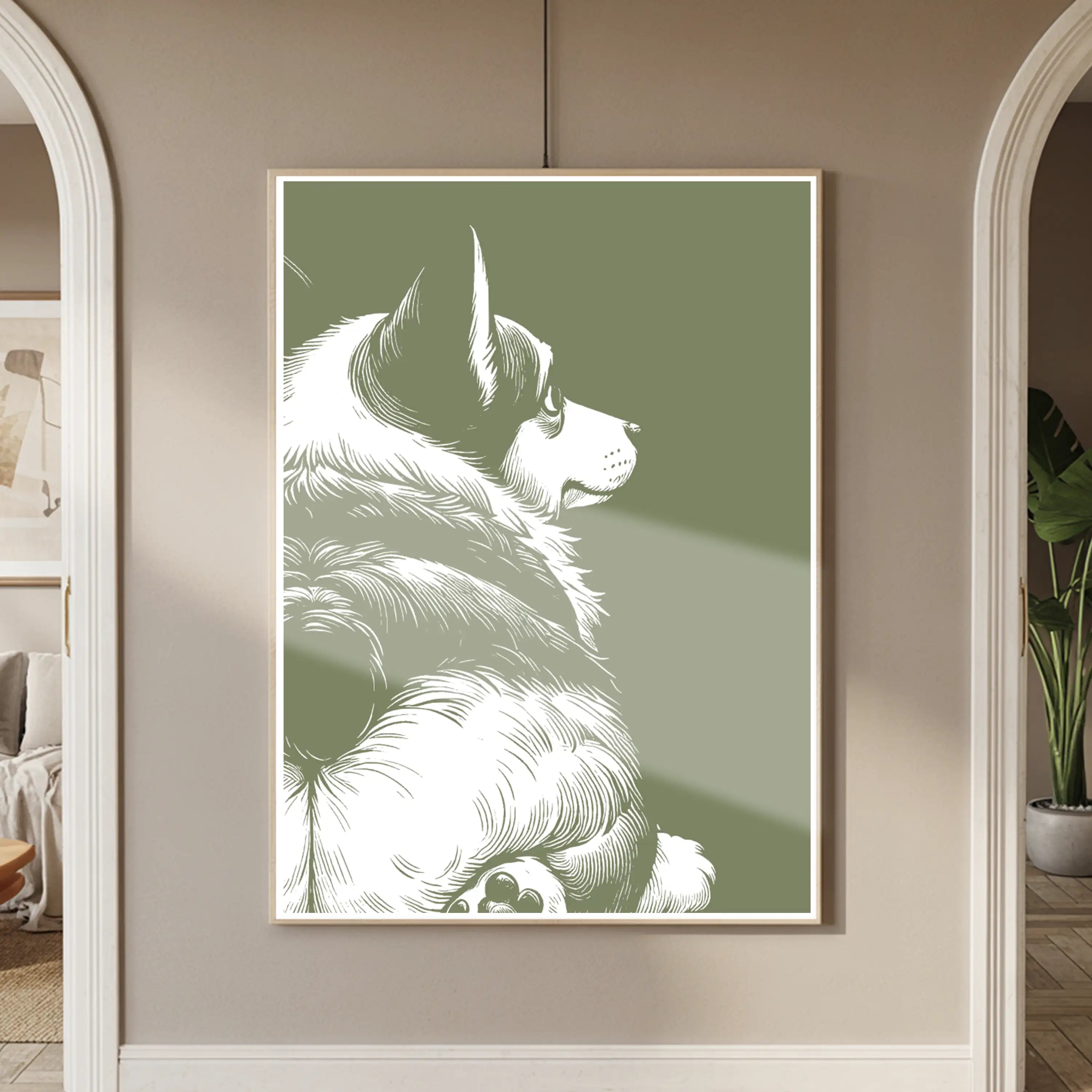 Framed artwork of a crogi showing his butt on a green background in a room with neutral decor.